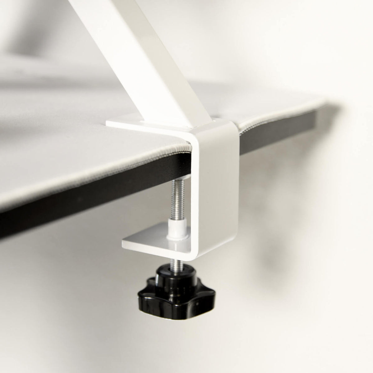 Arozzi Europe Desk Riser - Large clamps objects to desks securely with a screw mechanism.